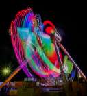 Colorful motion blur of spinning ride at a carnival. Art Print